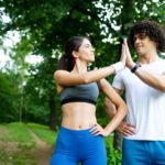 Happy young woman doing excercise outdoor in a park, jogging