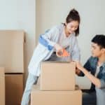 Young couple moving boxes in new home